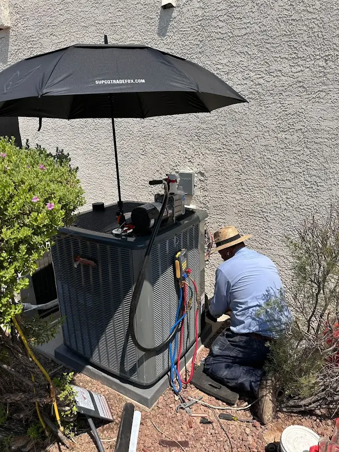 HVAC technician performing outdoor AC maintenance in Beacon Square